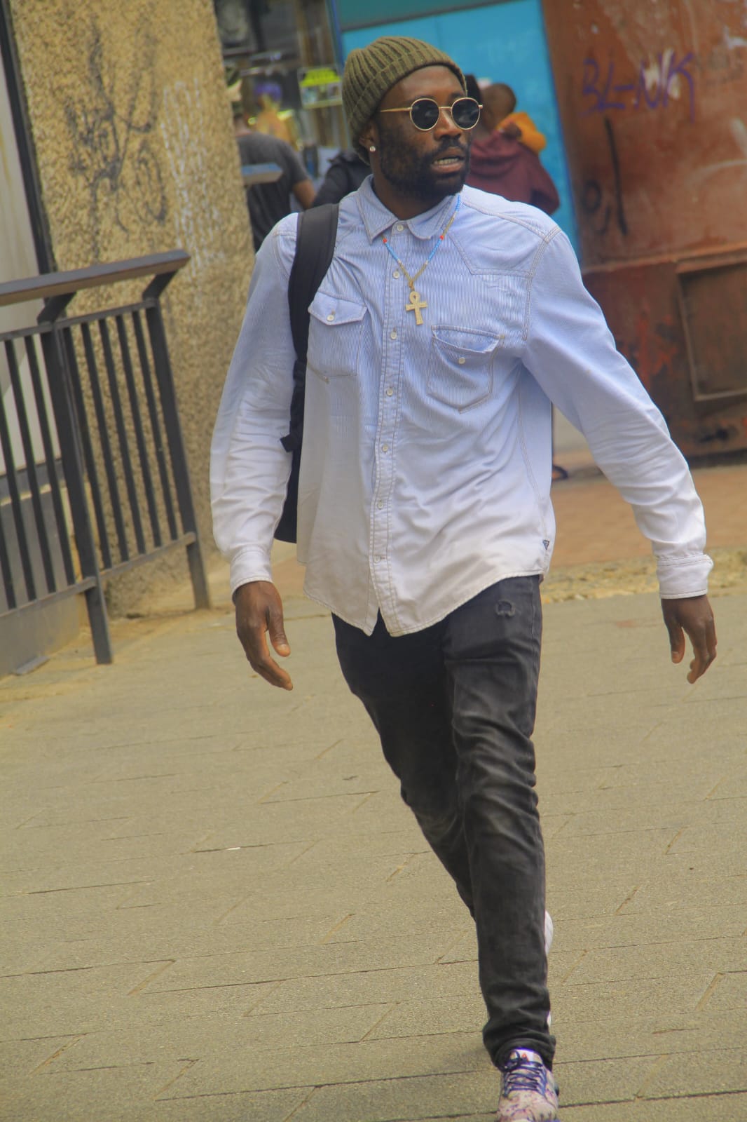 B.E. Mhlanga walking outdoors